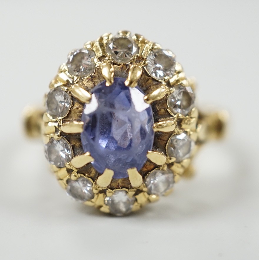 An early to mid 20th century yellow metal, sapphire and diamond set oval cluster dress ring, size